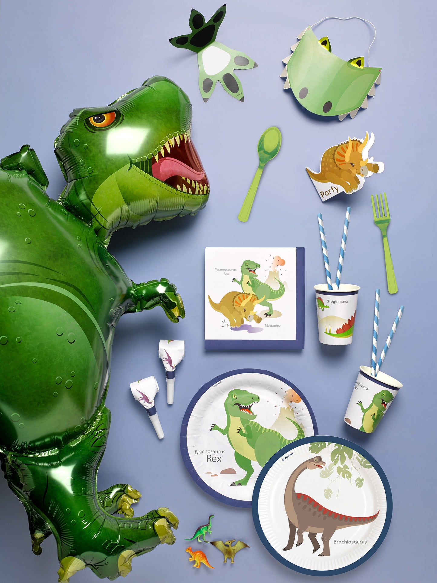 Vue d'ensemble des gobelets en carton grands dinosaures avec d'autres décorations de fête assorties