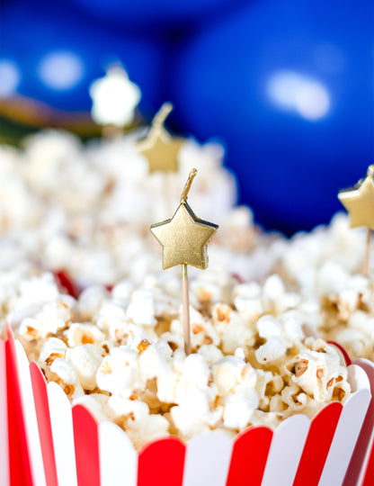 6 свещи върху златни топери за торта във формата на звезда