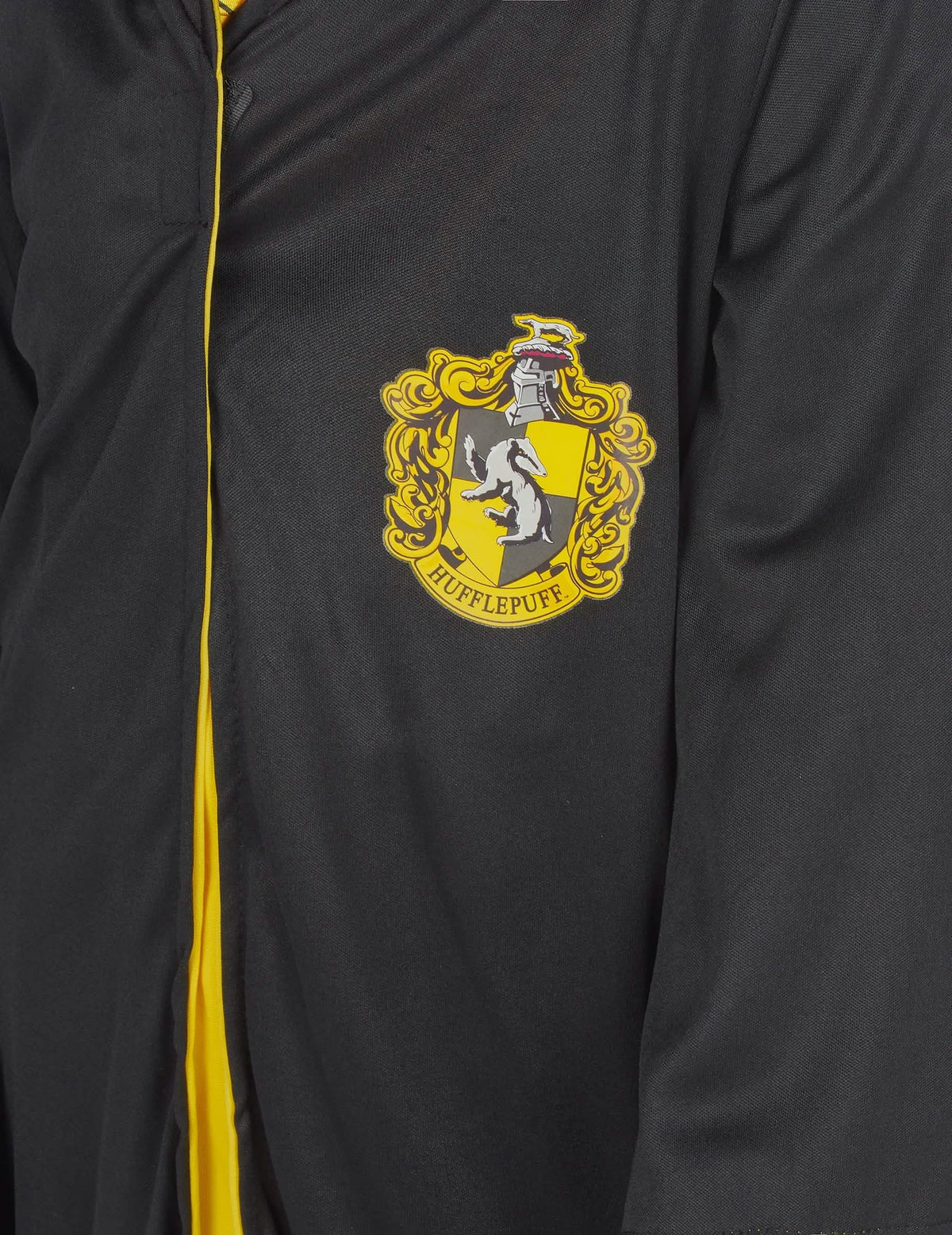 Детайл на емблемата на класическия костюм Пуфъндъл Harry Potter™ дете