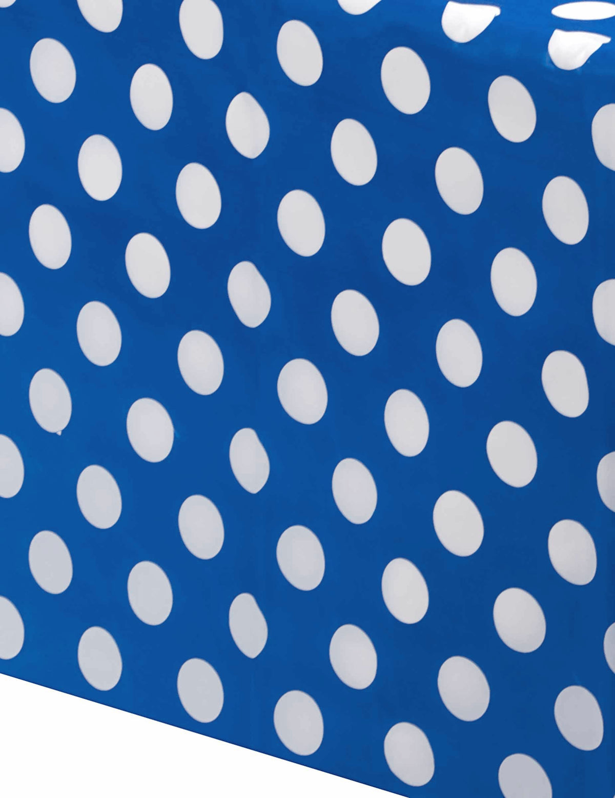Gros plan sur les motifs de la nappe à pois blancs pour fête bleu marine