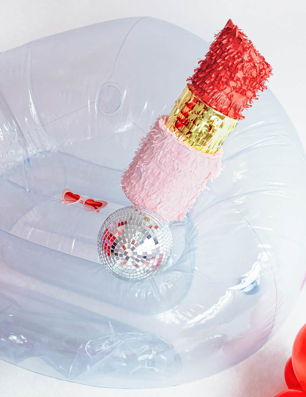 Mise en scène avec boule à facettes et lunettes de la piñata rouge à lèvres